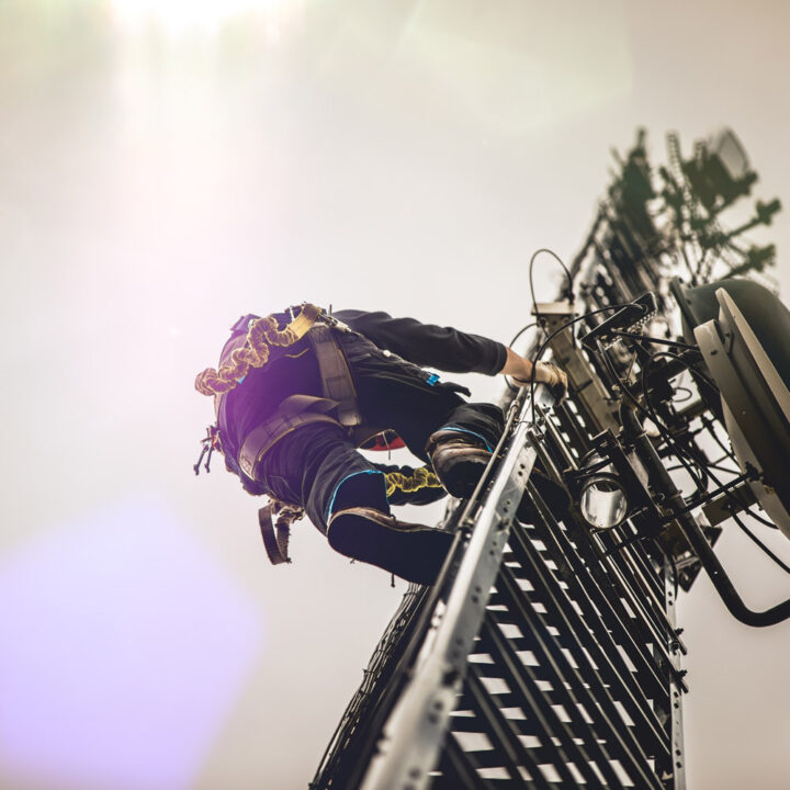 Man climbing a cell tower