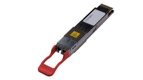 A computer network transceiver module with a red pull tab, metal casing, and warning sticker.