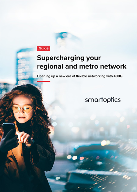 Woman using smartphone in city with text about supercharging regional and metro network, Smartoptics logo visible.