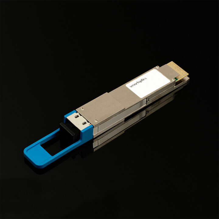 A silver optical transceiver module with a blue pull tab on a black reflective surface.