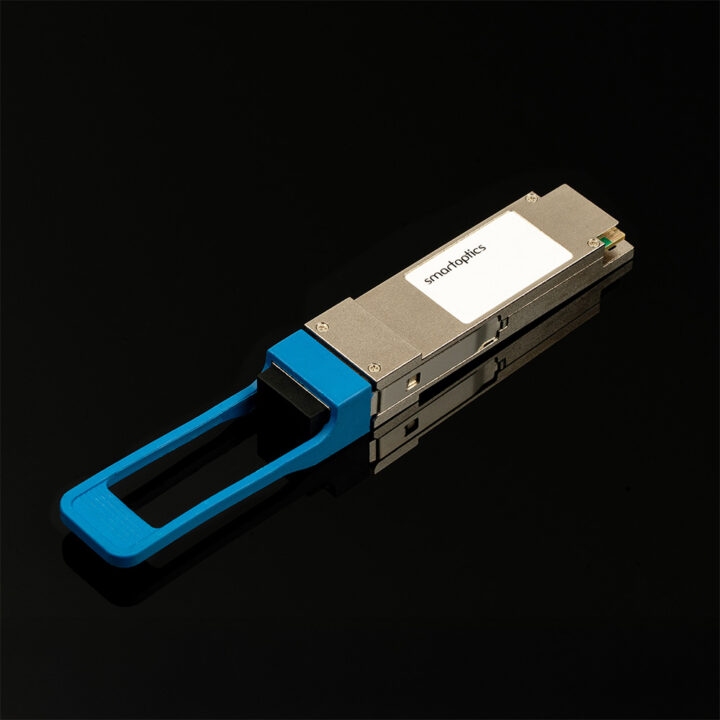 A fibre optic transceiver module with a blue pull-tab on a black reflective surface.
