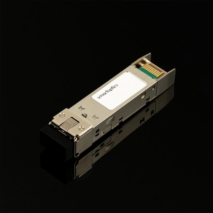 A metal optical transceiver module labeled "smartoptics" on a reflective black surface.