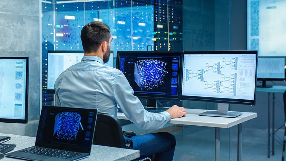 Man analysing data on multiple monitors in a server room, displaying digital and network diagrams.